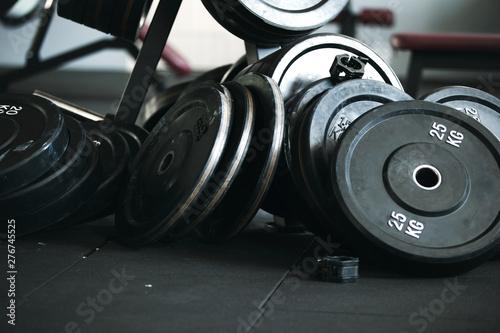 Gym equipment for work out. Gym pancakes scattered around the gym.