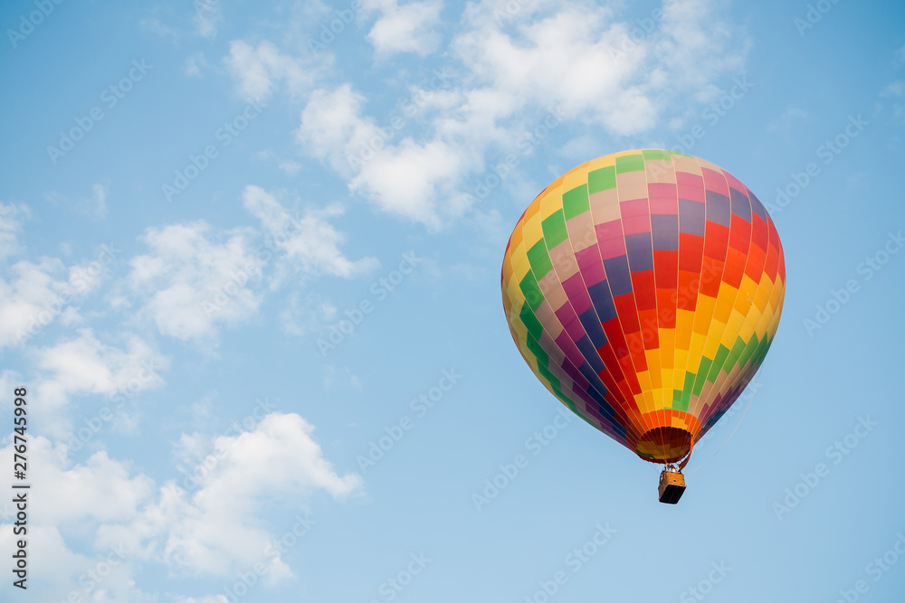Colorful hot air balloon moving up in blue sky. Colorful hot air balloon moving up in blue sky.