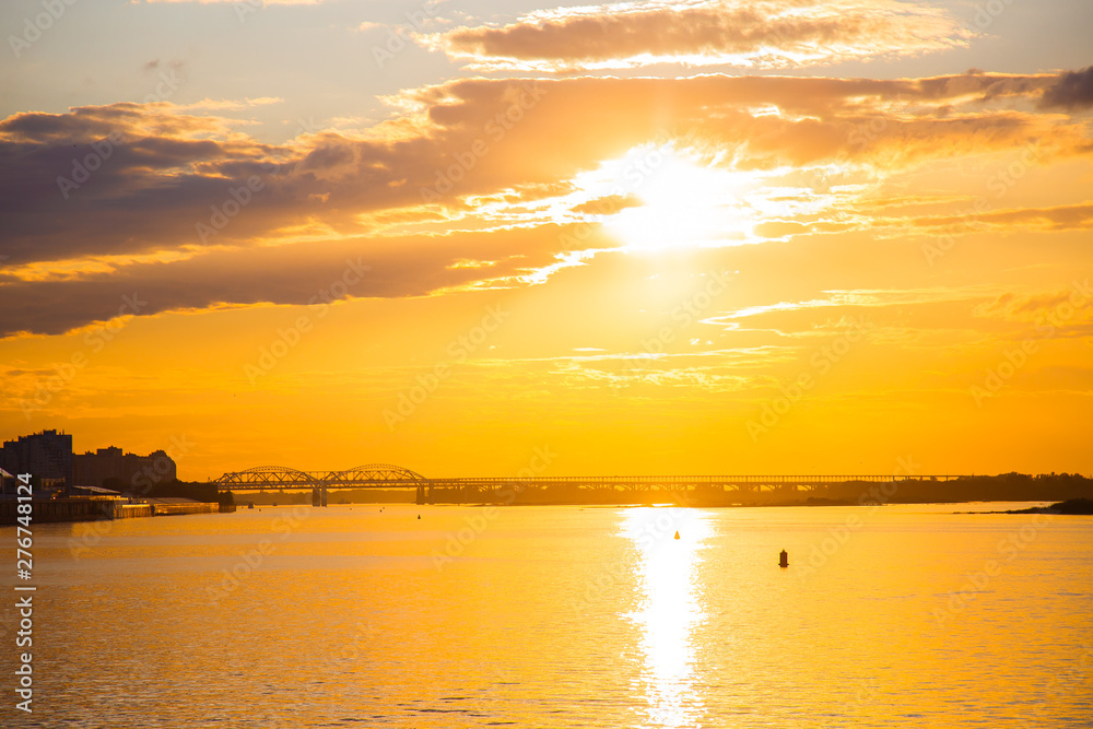 Sunset in the city on the Volga river. Seagulls fly over the river Sunset in the city on the Volga river. Seagulls fly over the river