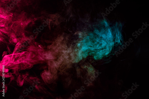 Colored background with winding clouds of smoke from patterns of different forms of pink  green and blue colors with tongues of flame on a black isolated background