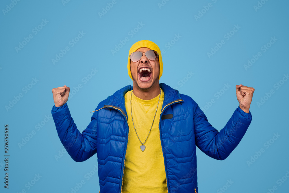 African male winner yelling and clenching fists African male winner yelling and clenching fists