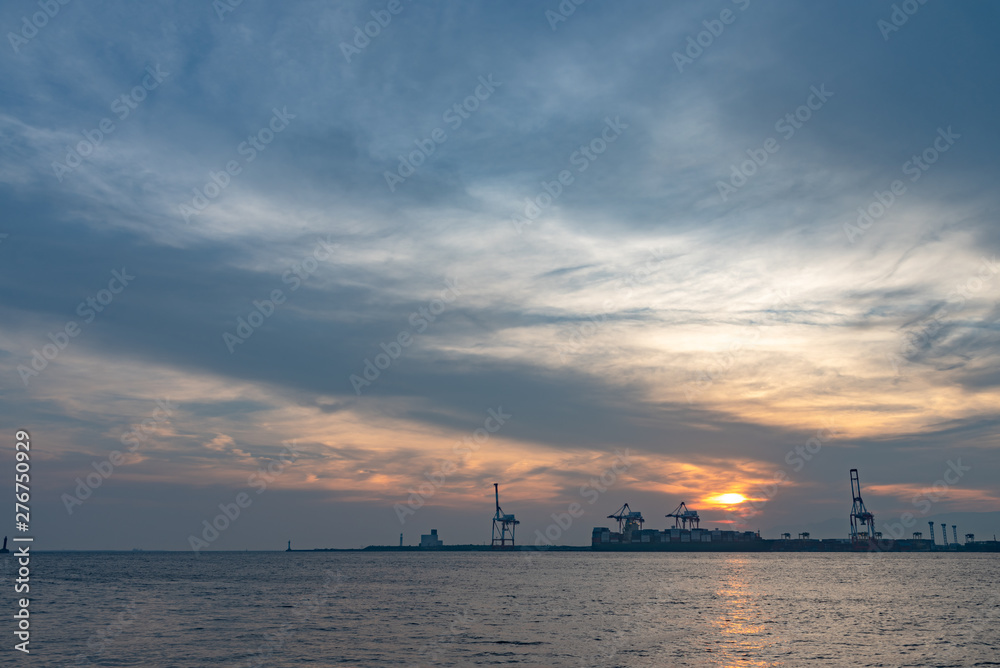 Osaka bay with Yumeshima island on background in summer sun set time, view from Osaka metro Cosmosquare train station park promenade Osaka bay with Yumeshima island on background in summer sun set time, view from Osaka metro Cosmosquare train station park promenade