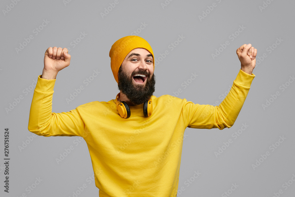 Naklejka premium Excited hipster dancing with clenched fists