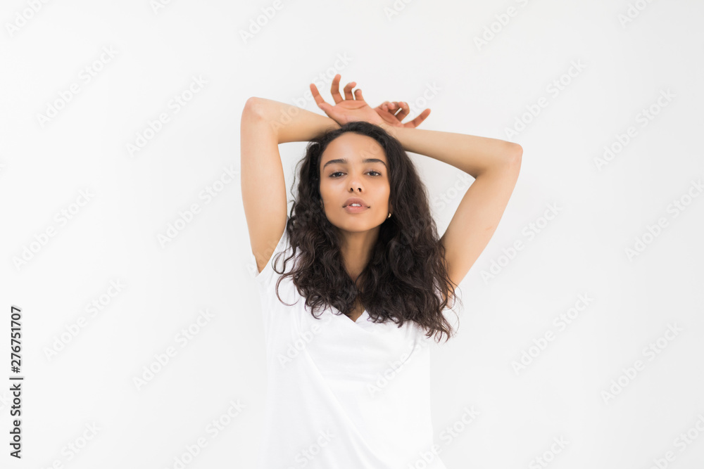 Portrait of dreaming brunette woman holding hands behind the had isolated on white background Portrait of dreaming brunette woman holding hands behind the had isolated on white background
