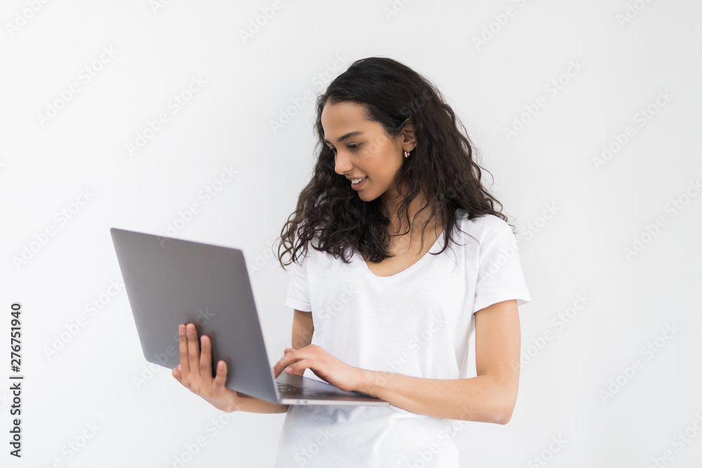 Thoughtful young woman using laptop on white background Thoughtful young woman using laptop on white background