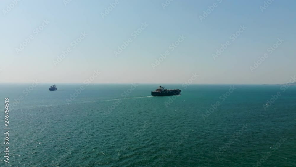 Aerial view of cargo ships in the sea are transported container to the port. Import export and shipping business logistic and transportation of International by ship Aerial view of cargo ships in the sea are transported container to the port. Import export and shipping business logistic and transportation of International by ship