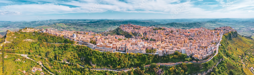 Panoramic view of the hills, the town of Enna on the valley with green meadows and forests in Sicily.