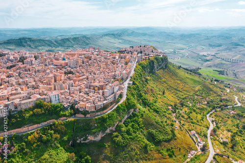 The town of Enna Italy Sicily on a hillside cliff, aerial view.