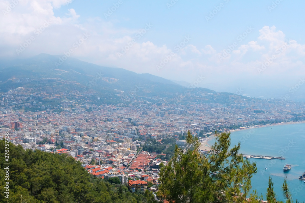 View of the fortress, the ruins on the Peninsula of Alanya, Turkey, Asia.Mediterranean sea, beautiful background. Famous tourist destination with high mountains. Part of an ancient Old castle.