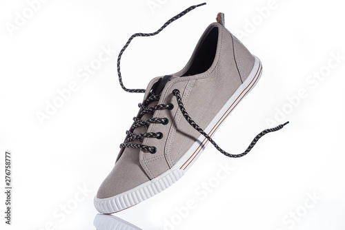 Beige men's sneakers on a white background.