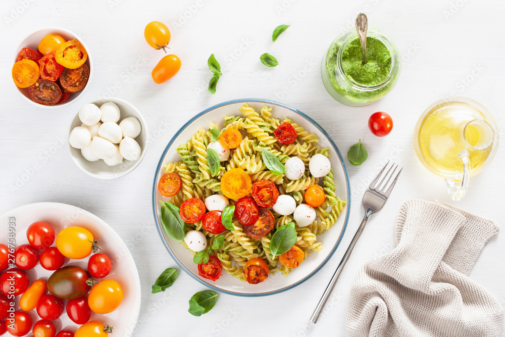 healthy fusilli pasta with pesto sauce, roasted tomatoes, mozzarella healthy fusilli pasta with pesto sauce, roasted tomatoes, mozzarella