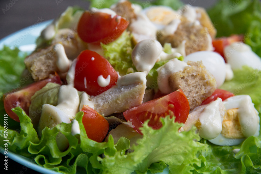 Salad with chicken, red tomatoes, eggs, cabbage, croutons and Caesar sauce Salad with chicken, red tomatoes, eggs, cabbage, croutons and Caesar sauce