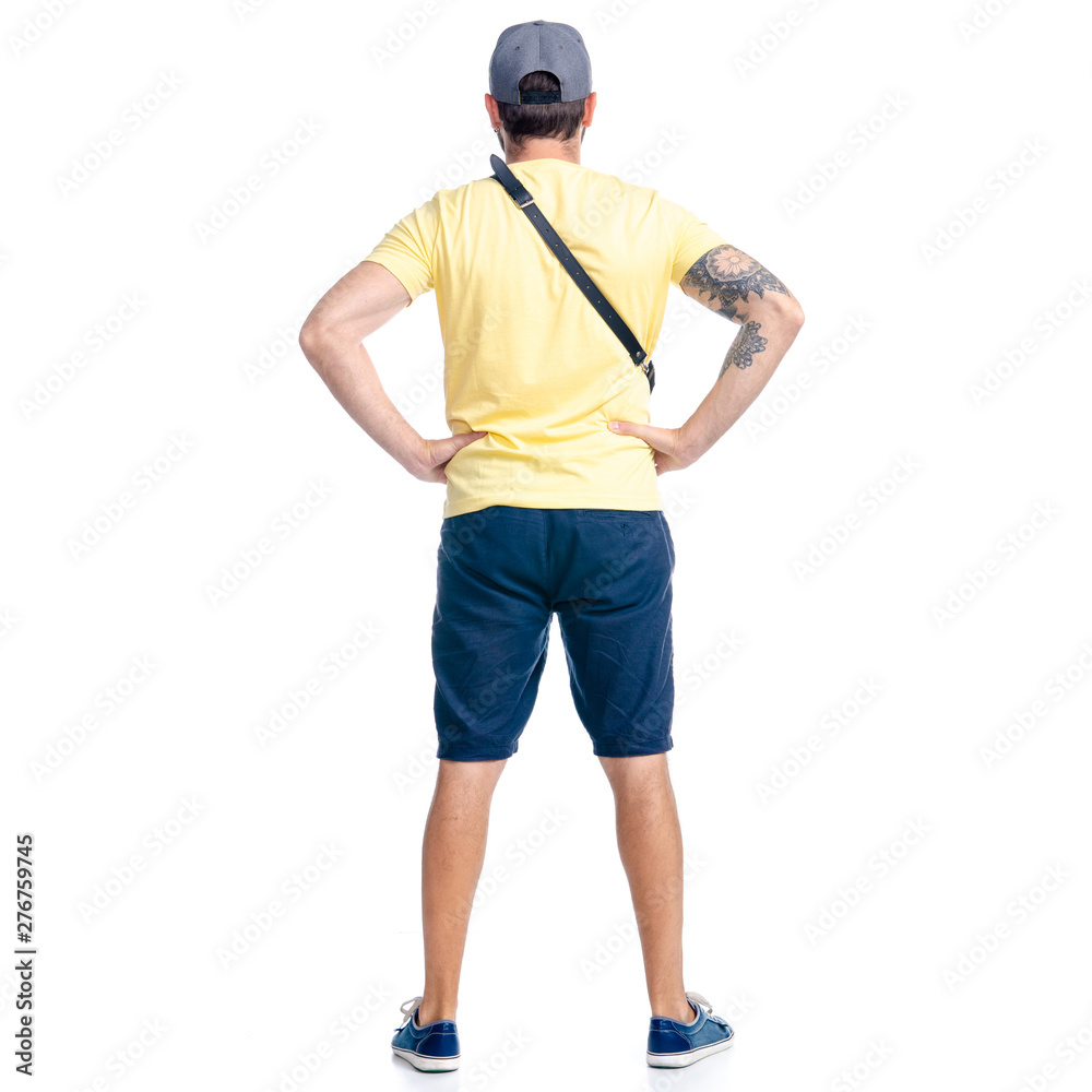 Man in shorts and cap standing looking on white background isolation, back view Man in shorts and cap standing looking on white background isolation, back view