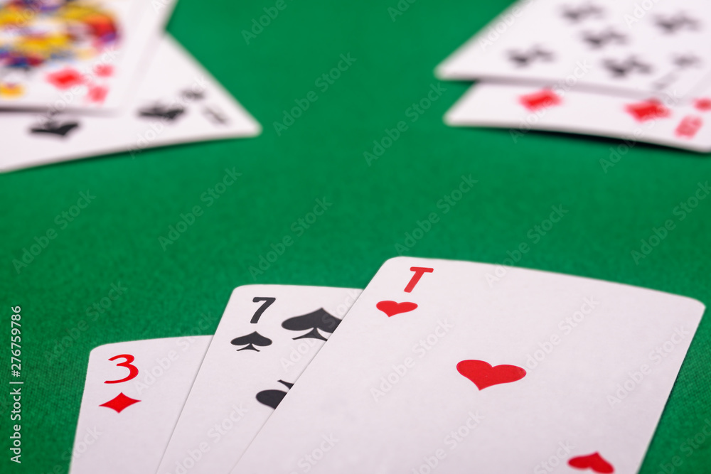 playing cards on a green table in different combinations close-up