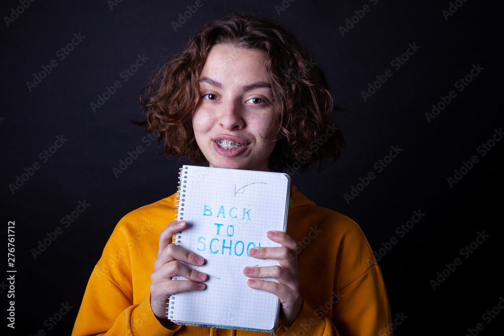 Young caucasian girl holding notebook with Back to School Young caucasian girl holding notebook with Back to School