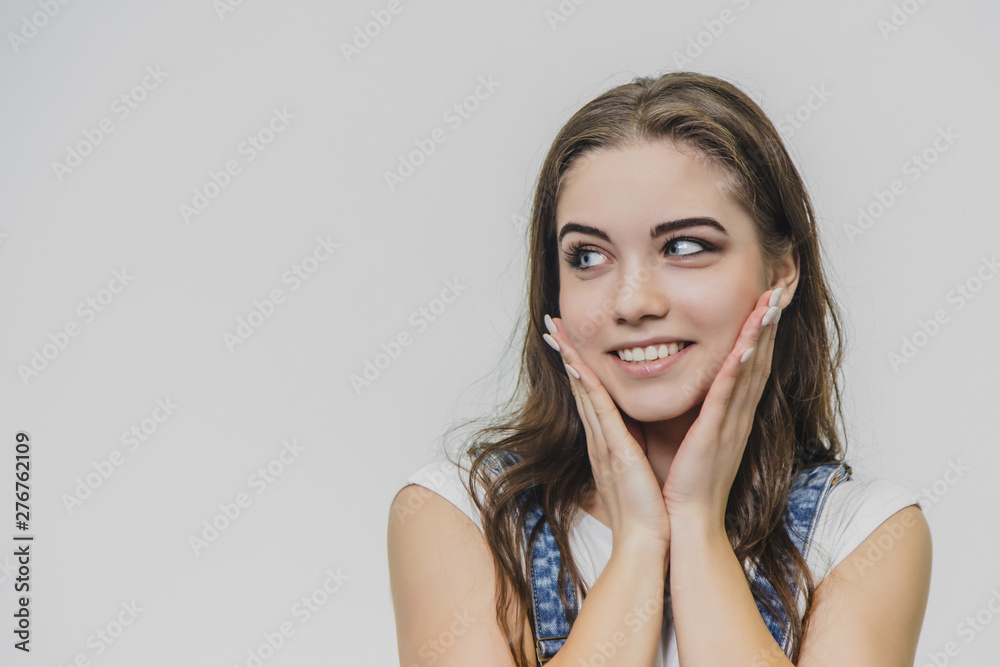 Horizontal portrait of a beautiful woman with a nice face. Wears a casual denim overalls and a white T-shirt. Isolated over white background. Horizontal portrait of a beautiful woman with a nice face. Wears a casual denim overalls and a white T-shirt. Isolated over white background.