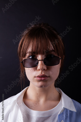 Caucasian Girl in white shirt with black sunglasses posing in the studio © frimufilms