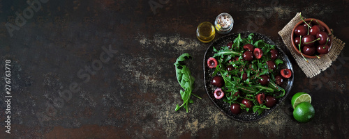 Healthy dietary salad with sweet cherries and arugula. Fitness salad. Raw diet.