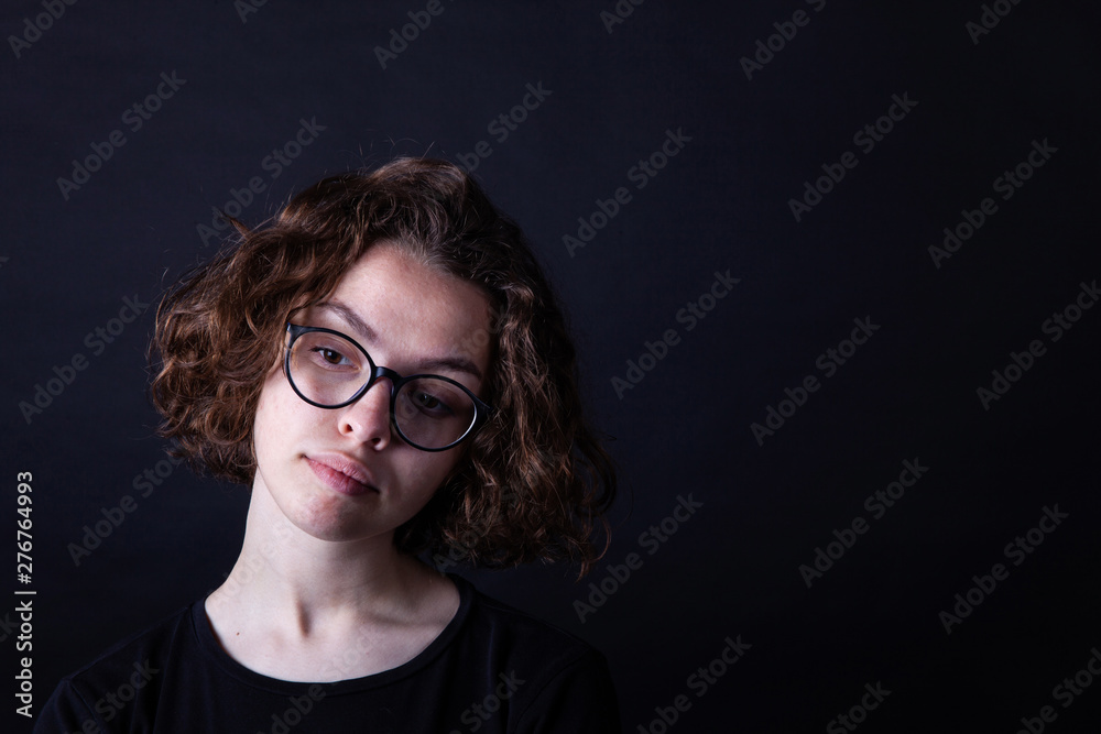 Young caucasian highschool girl with curly hair and round eyeglasses Young caucasian highschool girl with curly hair and round eyeglasses