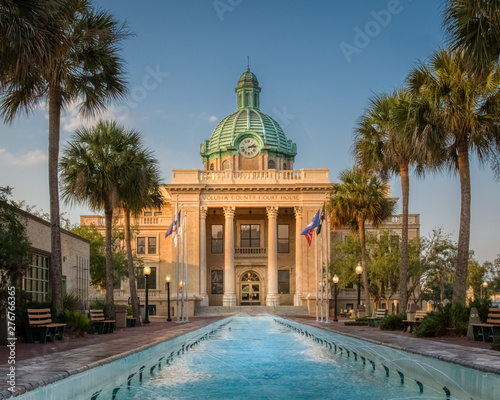 Historic Volusia County Courthouse with copper dome from fountain pool in DeLand, Florida. photo