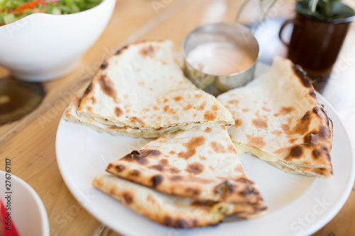 food and south asian cuisine concept - close up chapati bread on table of indian restaurant