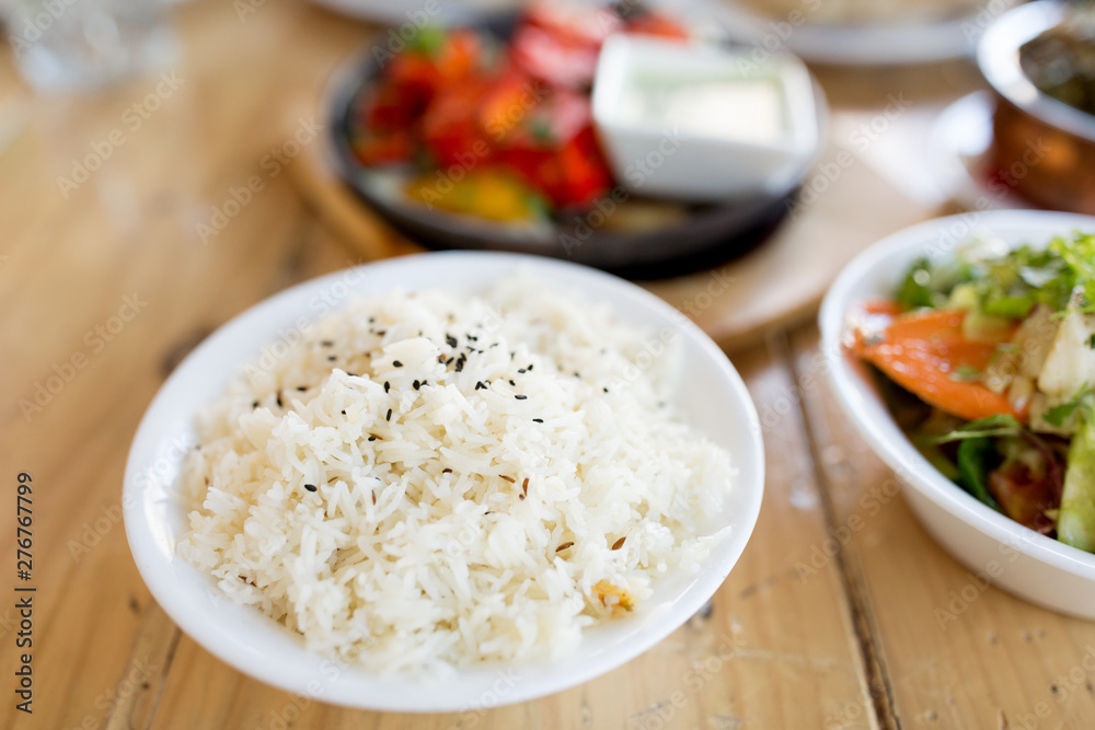 food, south asian cuisine, culinary and cooking concept - close up of boiled rice in bowl on table of indian restaurant food, south asian cuisine, culinary and cooking concept - close up of boiled rice in bowl on table of indian restaurant