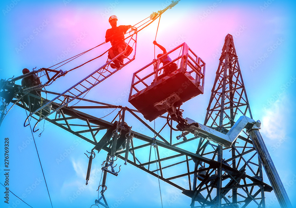 Engineer Electrician Workers On Lift Repairing Electricity Pylon Powerline And Wires Engineer Electrician Workers On Lift Repairing Electricity Pylon Powerline And Wires