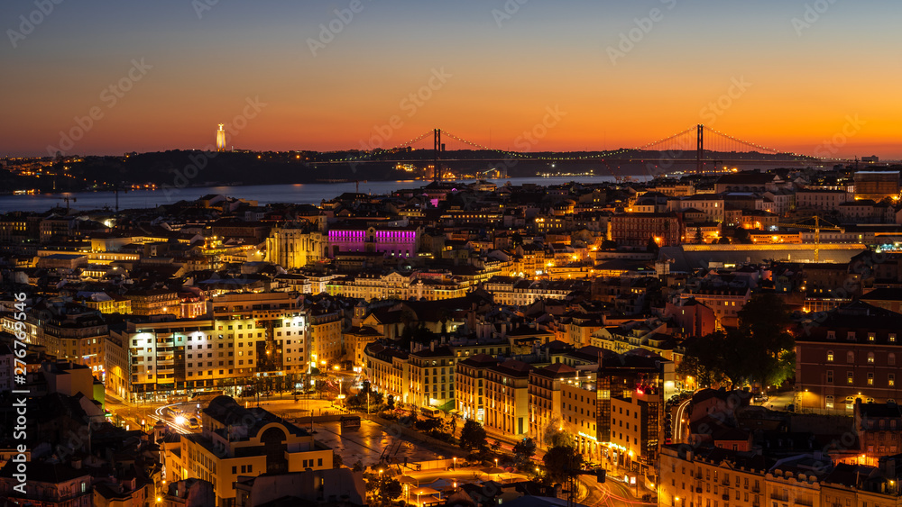 Panorama of Cityscape of illuminated Lisbon (Lisboa) Portugal, from a viewpoint, after summer sunset against sky.