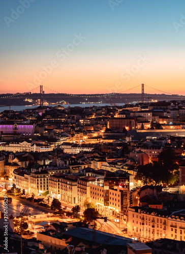 Panorama of Cityscape of illuminated Lisbon (Lisboa) Portugal, from a viewpoint, after summer sunset against sky.