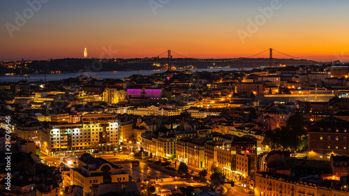 Panorama of Cityscape of illuminated Lisbon  Lisboa  Portugal  from a viewpoint  after summer sunset against sky.