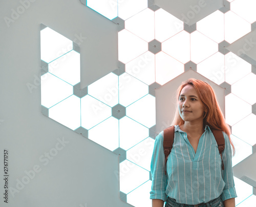Asian tech woman standing in front of illuminated block chain sign - Crypto currency social influencer girl thinking about future technology trends - Finance, tech and millennial generation concept