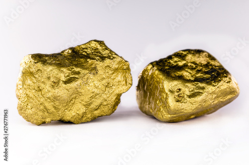 Gold stone in high resolution. Gold on white background isolated. Mineral extraction concept.