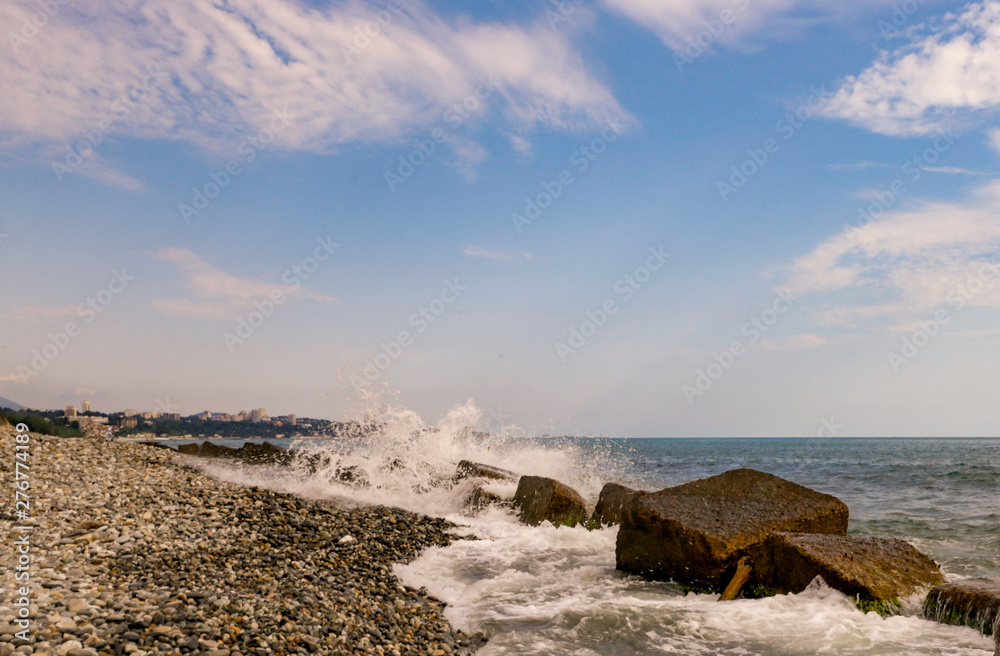 Fototapeta premium white waves smash on rocks on the beach