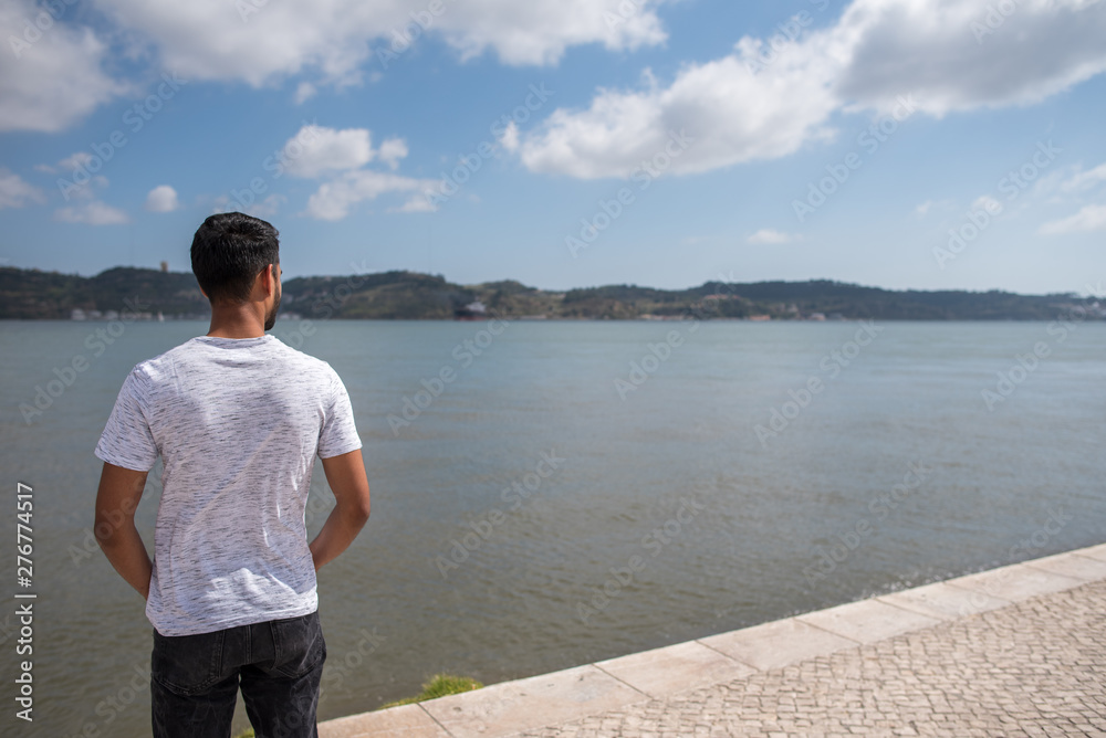 Male model posing in font of river