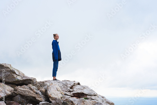 Mid age woman taking selfie at the top of mountains