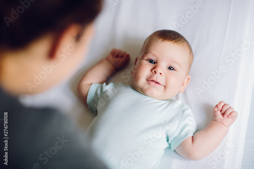 Mother playing with adorable happy baby