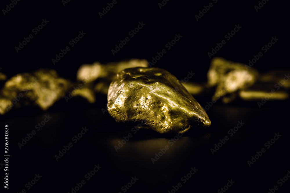 Golden stone in high resolution. Gold on black background isolated. Concept of luxury and wealth. Golden stone in high resolution. Gold on black background isolated. Concept of luxury and wealth.