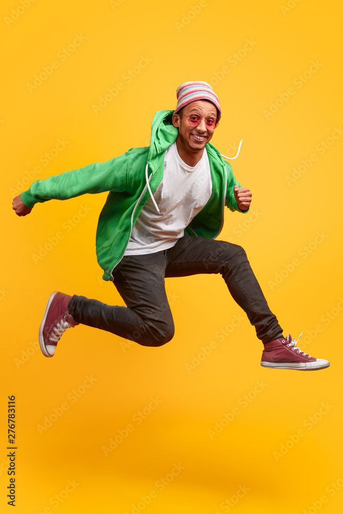 Funny black guy smiling and jumping Stock Photo | Adobe Stock