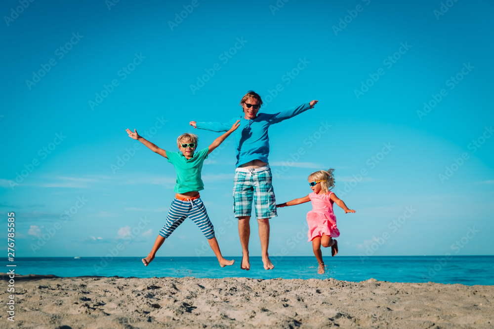 happy father with kids-boy and girl- play at beach happy father with kids-boy and girl- play at beach