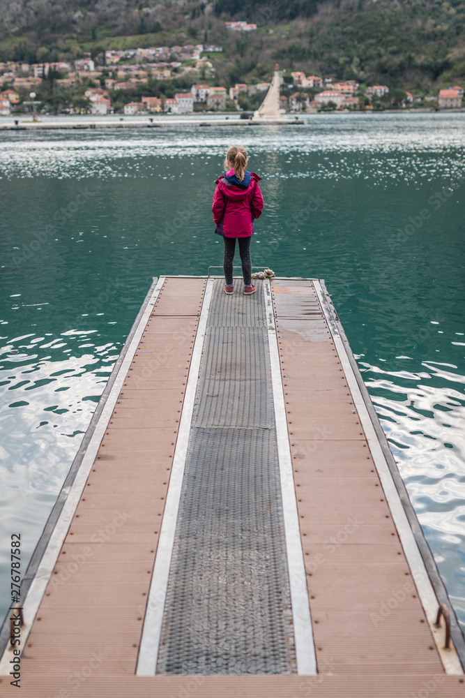 Girl standing on the  pier