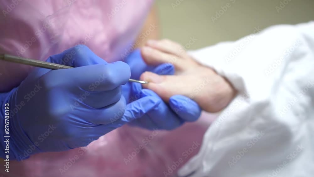 The girl in the center of the hardware pedicure do the procedure.