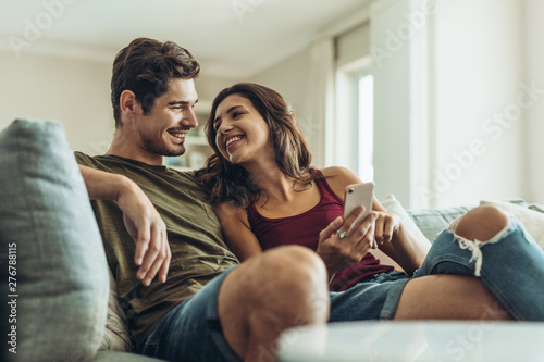 Loving couple relaxing on sofa