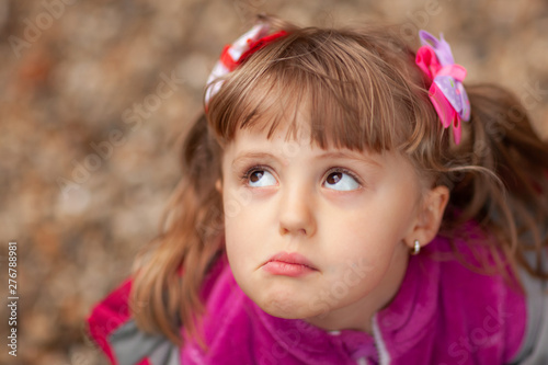 Grumpy little girl making faces