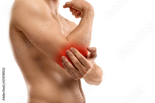 Crop guy rubbing aching elbow