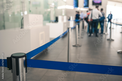 blue ribbon restriction of movement for people before check-in at the airport.