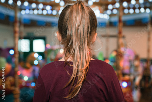 Girl with a ponytail in an indoor amusement playground