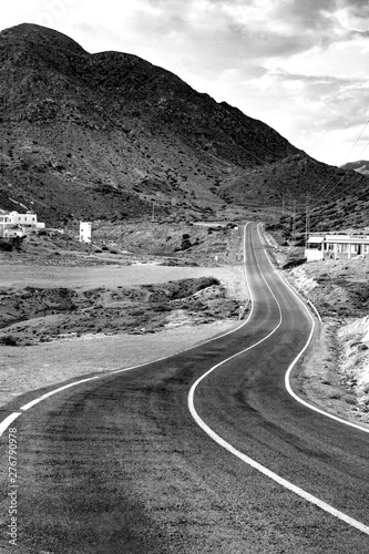 ROAD AND MOUNTAINS IN THE HORIZON. BLACK AND WHITE PHOTOGRAPHY