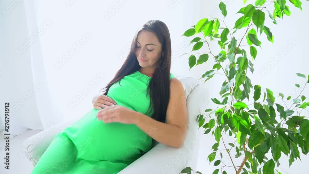 happy pregnant woman touching her tummy at home happy pregnant woman touching her tummy at home