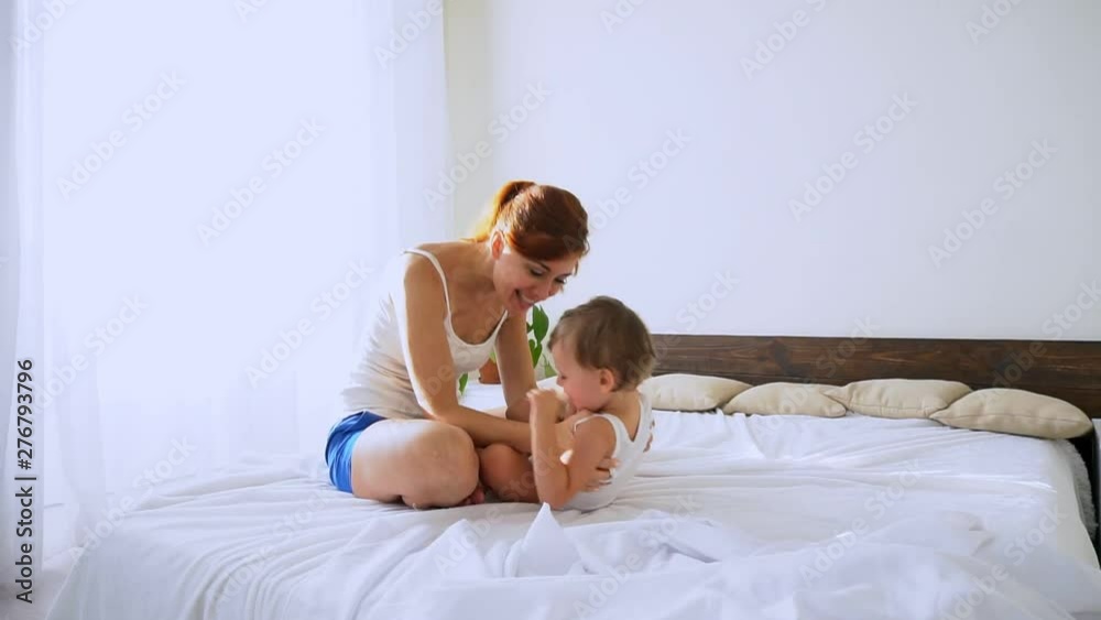 Mom plays with her son in the bedroom Mom plays with her son in the bedroom