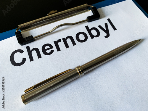 Radiation hazard. Documents of Chernobyl on a black table